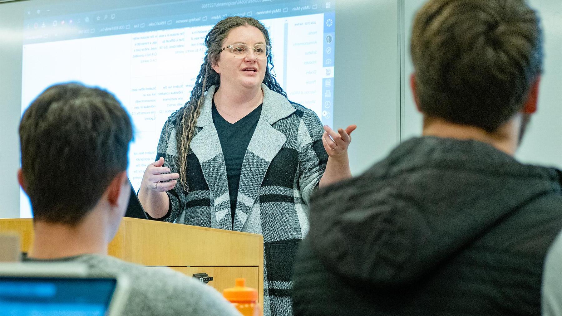 Teacher giving a lecture in front of her students